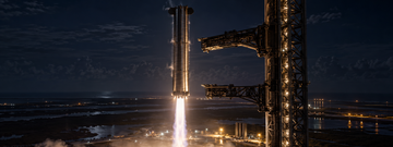 Starship booster approaching catch arms at a Florida launch tower at night