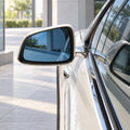 Visual illustration of blue replacement side-mirror glass installed in the existing vehicle mirror housing.