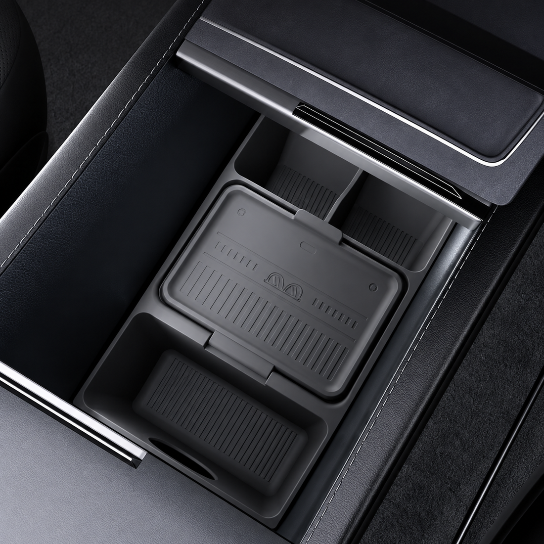 A black silicone car center console organizer tray shown installed inside a console and also as a standalone product shot on a white background.