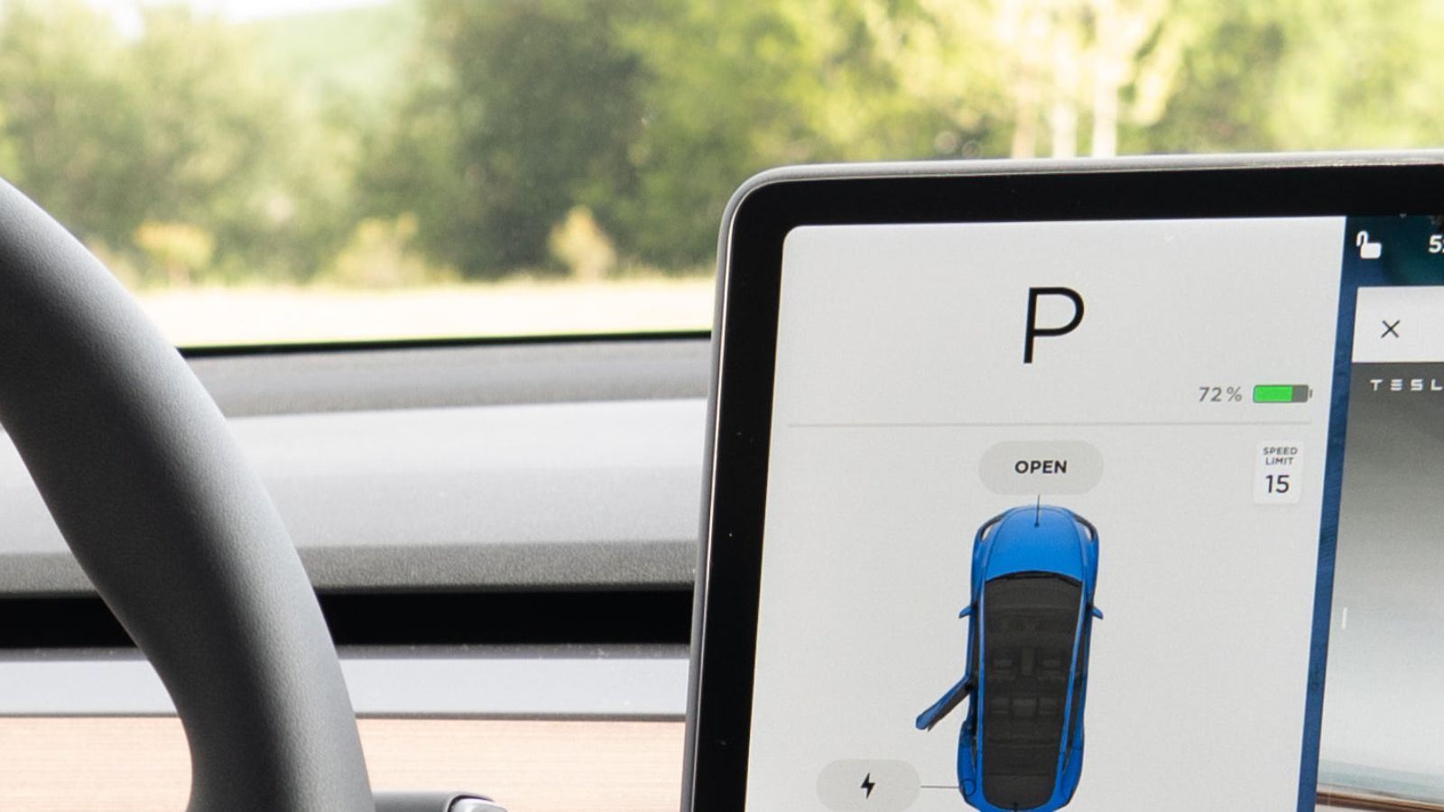 Close-up of a car's infotainment screen displaying the parking gear indicator.