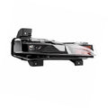Front three-quarter view of a bumper-light assembly with a dark inner housing and amber end section.