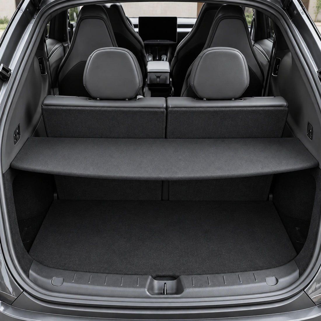 One rigid black fabric cargo cover and two clip-in brackets for Tesla Model YL on a white background.