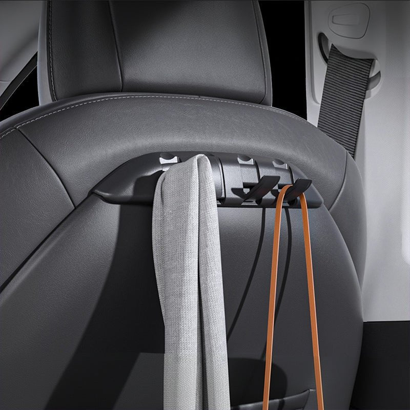 TESERY seat-back hook organizer in a Tesla Model 3/Y, holding a tote bag and scarf behind the front seat.